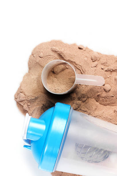 istock Shaker, scoop and chocolate whey protein or mass gainer powder 1369975028
