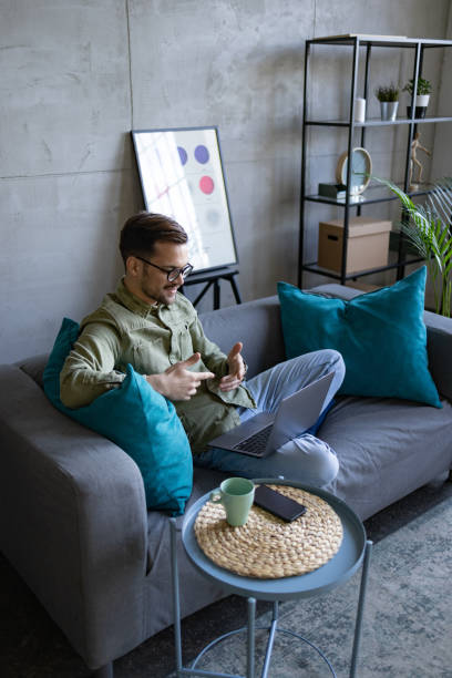 istock High angle view of a young Caucasian man using a laptop at home 1369976343