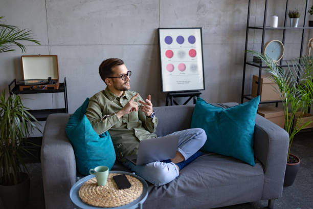 istock High angle view of a young Caucasian man using a laptop at home 1369976500