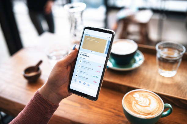 istock Managing online banking on cafe. 1369976759