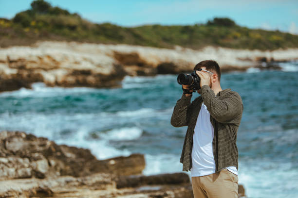 istock professional photographer shooting seascape 1369976846