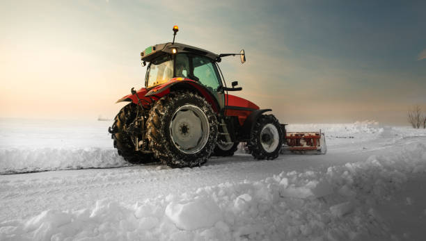 istock Tractor cleaning snow in field 1369977663