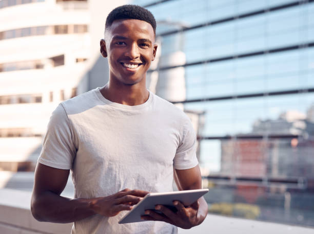 istock Shot of a young businessman using his digital tablet 1369978293