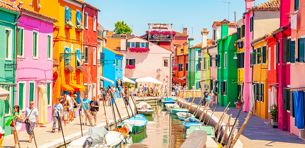 Burano, Italy - 2 June, 2021: Scenic view of water canal and colorful houses on Burano island.