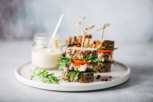 sandwich with tuna, arugula and tomato, selective focus