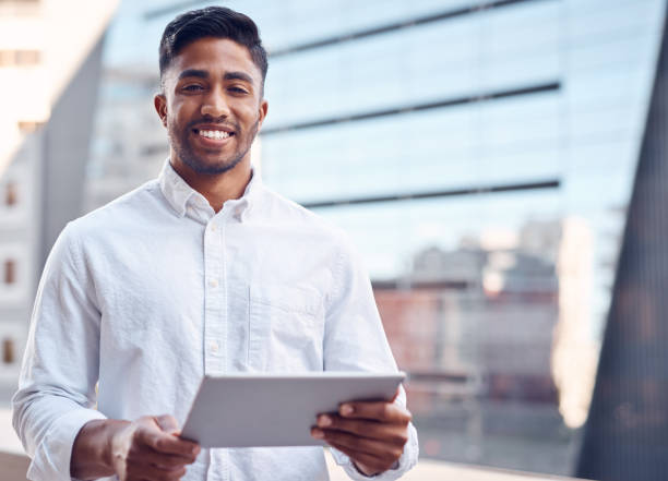 istock Shot of a young businessman using his digital tablet 1369979689