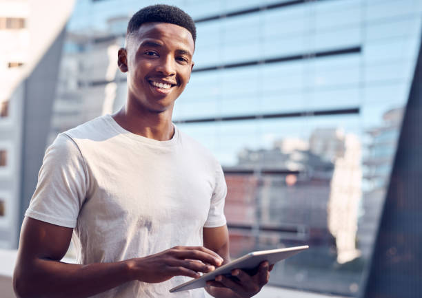 istock Shot of a young businessman using his digital tablet 1369979915