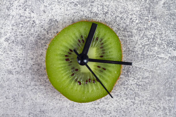 istock A clock made of green kiwi fruit shows the time 1369980470