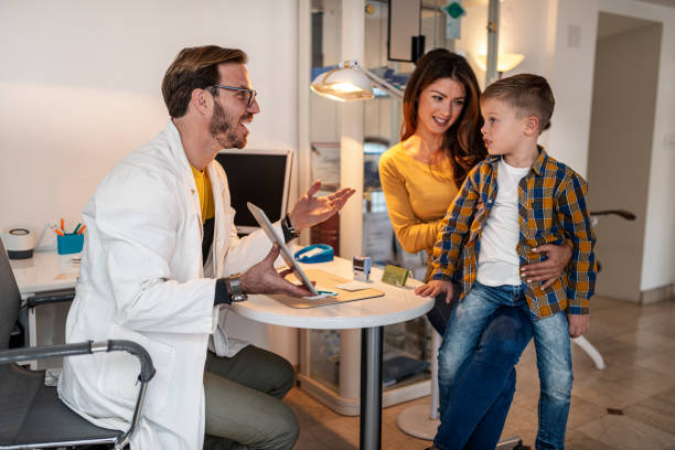 istock Mother with her son in an office with an ophthalmologist 1369982168