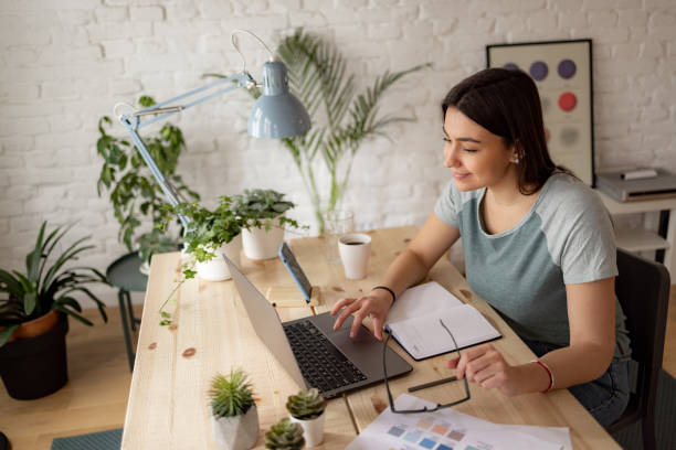 istock High angle side view of a successful Caucasian woman working from home using a laptop 1369983871