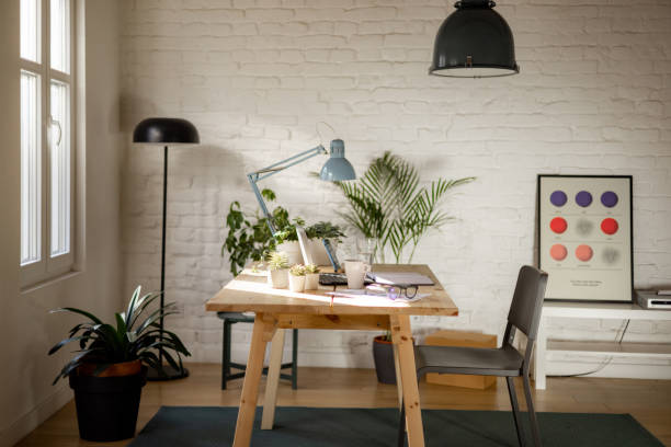 Home office with no people Nicely organized home office, empty of people, with a laptop and other office necessities neatly arranged on the working table desk lamp stock pictures, royalty-free photos & images