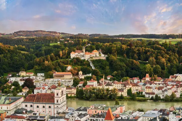 View from the Veste Oberhaus, Passau incl. Cathedral, Inn river, Innstadt, Mariahilf located in Lower Bavaria, Bavaria, Germany. Mariahilf in the middle is a pilgrimage church including the monastery and pilgrimage stairs. There are a many details to find like the Inn river, cathedral etc. Taken just before sunset. City view from Passau including the associated landscape to Austria. English translation: View from the Veste Oberhaus over Passau with cathedral, Inn, Innstadt, Mariahilf, Lower Bavaria, Bavaria, Germany The focus is on the pilgrimage church Mariahilf with monastery and pilgrimage staircase. Taken just before sunset. City view from Passau / Innstadt including the associated landscape to Austria.