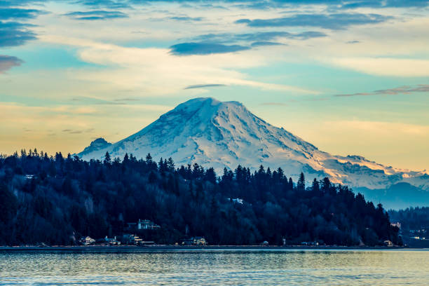 Water And Mountain Sunset 5 A view ofr Mount Rainier from Burien, Washington at sunset. mt rainier stock pictures, royalty-free photos & images