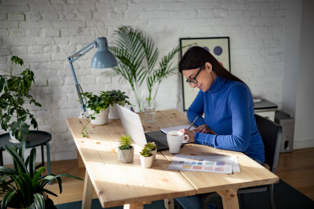 istock Side view of a successful Caucasian woman working from home using a laptop 1369986008