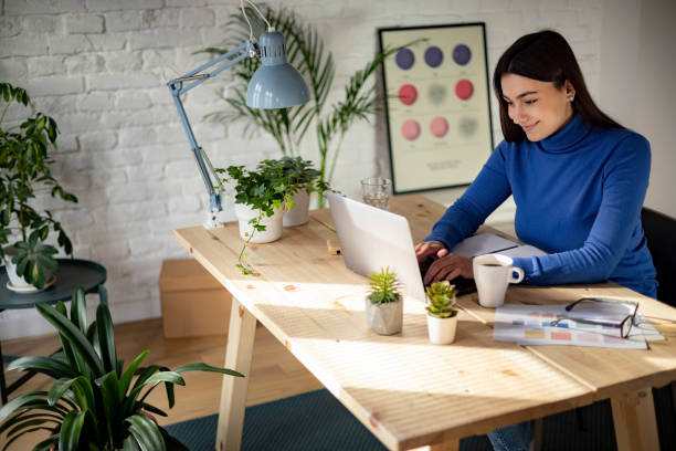 istock High angle view of a successful Caucasian woman working from home using a laptop 1369986108