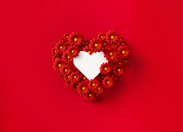 istock Valentine's Day Concept - White Heart Shape Nested Inside Of A Heart Shape Formed By Red Daisies Over Red Background 1369987241
