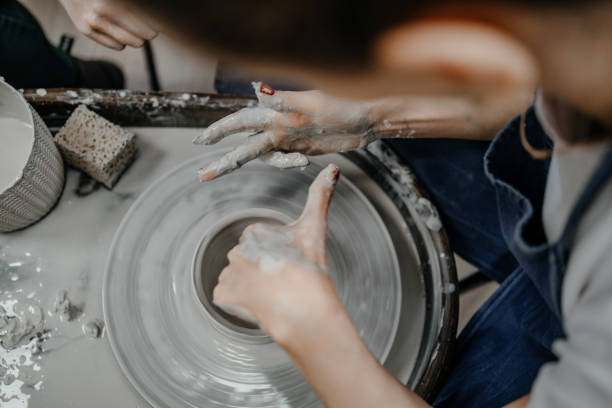 istock Sculpting from gray clay on a potter's wheel 1369990796