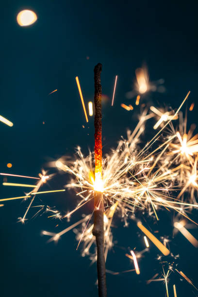 istock Christmas bengal fire sparkles against the black background. 1369992110