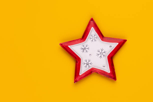 istock Christmas star decor on yellow colored background. 1369992373