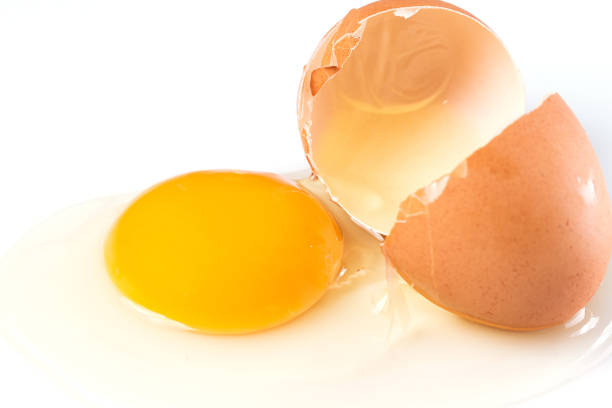 istock Broken chicken egg with a yolk and egg white pouring out 1369992467