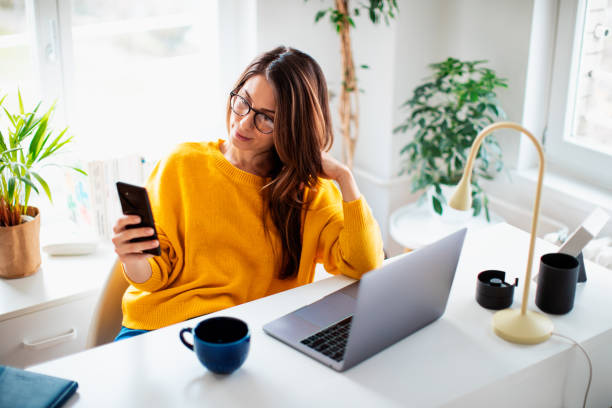 istock Beautiful young woman working at home 1369992800