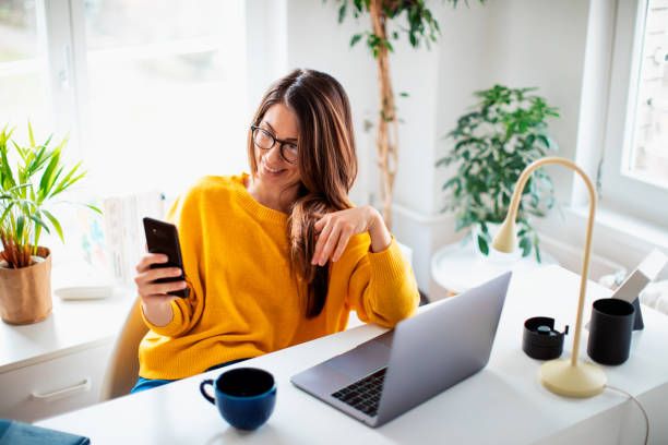 istock Beautiful young woman working at home 1369992801