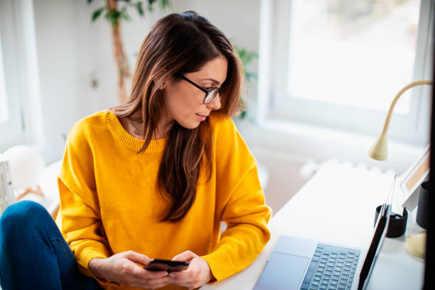 istock Beautiful young woman working at home 1369992830