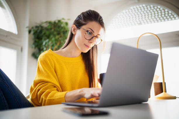 istock Beautiful young woman working at home 1369993675