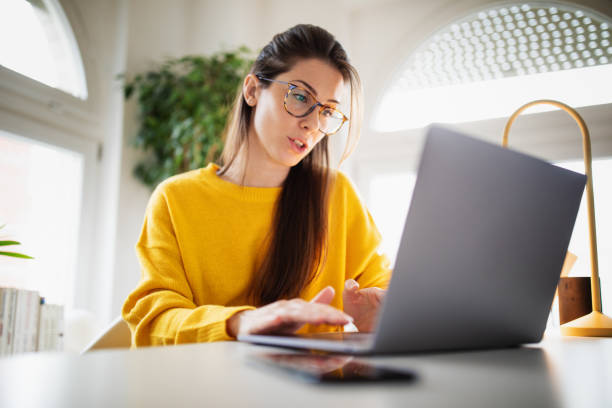 istock Beautiful young woman working at home 1369993683