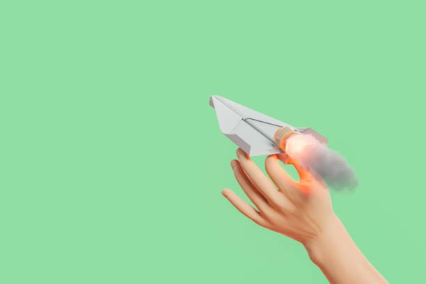 hand launching a propelled paper airplane