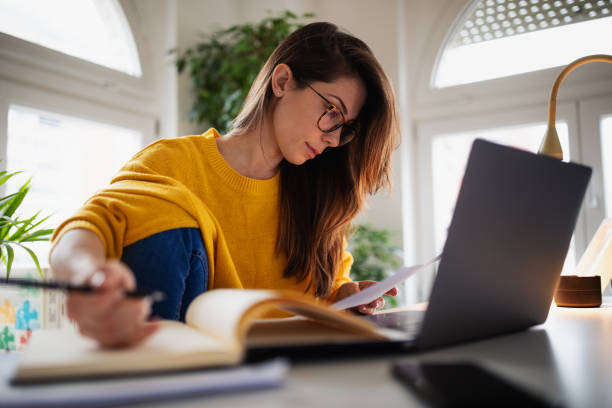 istock Beautiful young woman working at home 1369993805