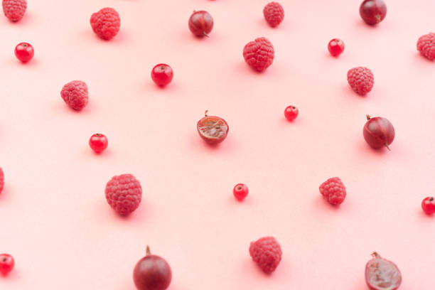 Ripe red berries on a plate. Berries of strawberries, raspberries and currants. Close-up. Sweet and juicy berries on a white background.