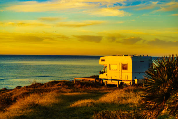 istock Camper vehicle on beach at sunrise 1369995147