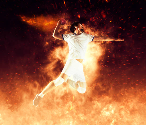 istock Handball player players on flames background 1369997937