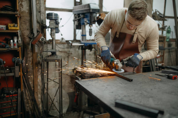 Manual worker on a workshop Confident young man grinding with sparks in repair shop steel grinding stock pictures, royalty-free photos & images