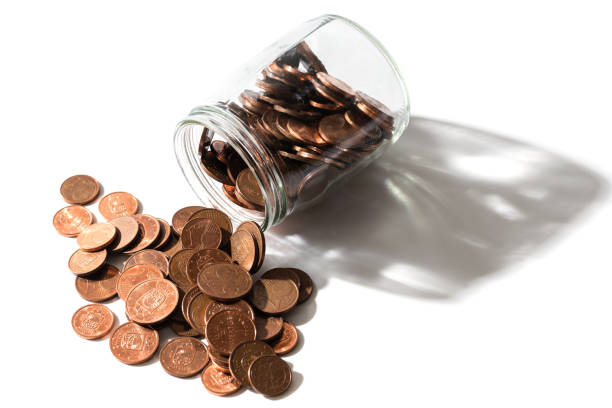 istock Shiny copper euro coins spilled from a glass jar. 1370001270