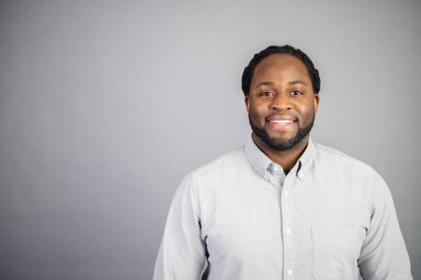 istock Smiling African-American man isolated on grey 1370004663