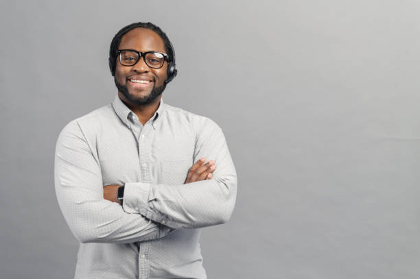 istock Smiling African-American man wearing headset isolated on grey 1370005982