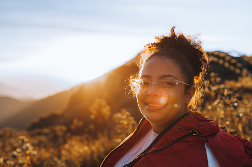 Woman smiling at sunset in the mountains of Itatiaia, Brazil
