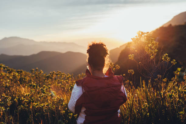 Woman enjoying winter sunset in the mountains of Itatiaia, Brazil Woman enjoying winter sunset in the mountains of Itatiaia, Brazil mantiqueira mountains stock pictures, royalty-free photos & images