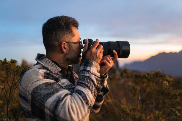 istock Professional photographer in the mountains at sunset 1370008252