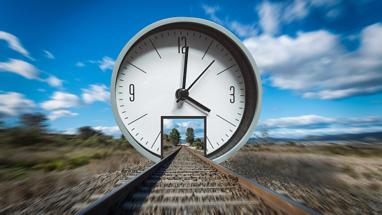 The train tracks pass through an analog clock. Concept of passage of time. Artistic collage.