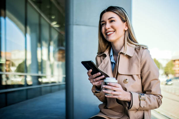 istock Young Business woman drinking coffee text messaging 1370009742