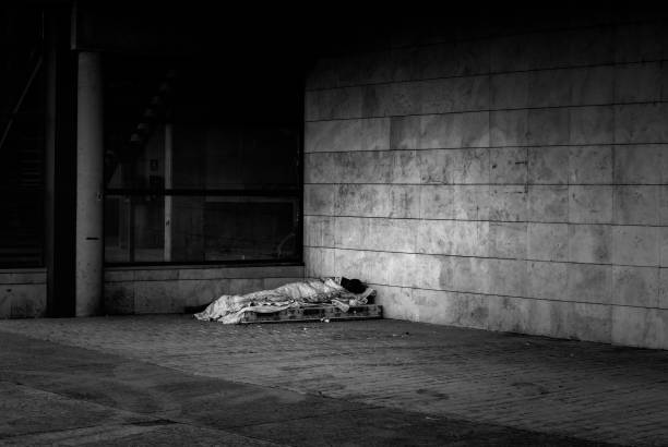 Person sleeping on the street Person sleeping on the street, homeless vagrant, social poverty homeless person stock pictures, royalty-free photos & images