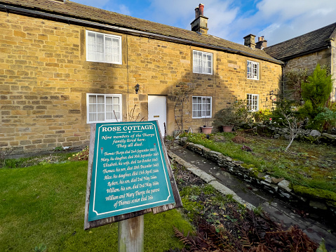 Eyam, United Kingdom - December 31, 2021: In 1665 residents of these cottages succumbed to the Bubonic Plague outbreak in the Peak District village of Eyam in Derbyshire, UK. The Bubonic plague ran its course over 14 months and one account states that it killed at least 260 villagers, with only 83 surviving out of a population of 350.