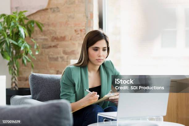 Mental Health Professional Uses Laptop To See Clients Stock Photo - Download Image Now
