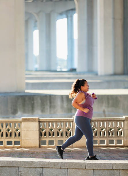 istock Pacific Islander woman running under city bridge 1370015613