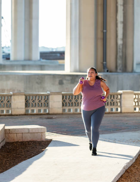 istock Pacific Islander woman running under city bridge 1370015633