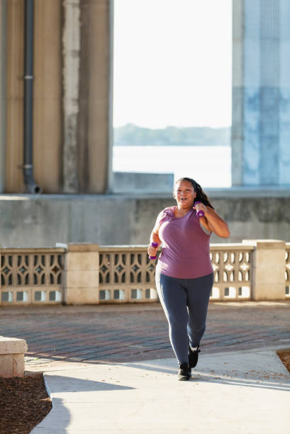 istock Pacific Islander woman running under city bridge 1370015634
