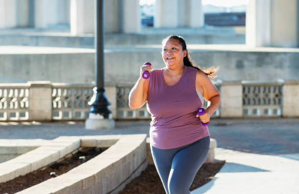 istock Pacific Islander woman running under city bridge 1370015712